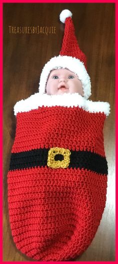 a crocheted santa claus bag with a baby in it's hat on top