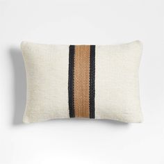 a white pillow with black and tan stripes