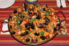 a large platter of seafood and rice on a table