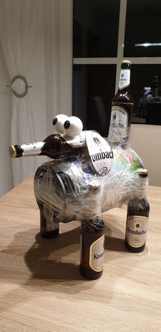 an elephant made out of beer bottles sitting on top of a table