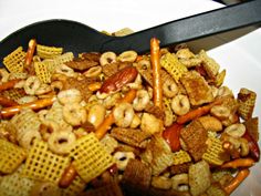 a bowl filled with cheetos and pretzels