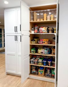 an organized pantry with lots of food in the cupboards and on the floor next to it