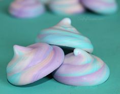 there are some candy shaped like fish on the table with blue and pink swirls