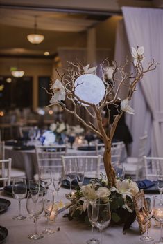 the table is set up with wine glasses and place settings for guests to sit at