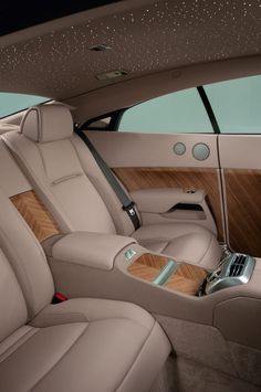 the interior of a luxury car with wood trim