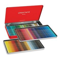 three tins of colored pencils in a red box with the lid open to show them