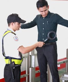 two men standing next to each other holding scissors