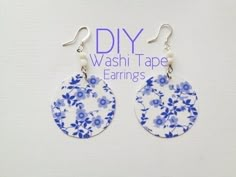 a pair of earrings with blue flowers on them