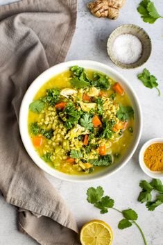 a white bowl filled with soup and garnished with cilantro