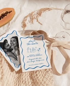 an image of a wedding save the date card on a table with wine glasses and watermelon slices