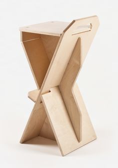 an open cardboard box sitting on top of a white surface with the lid opened to reveal a piece of furniture