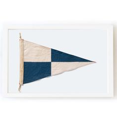 a blue and white flag hanging on a wall in front of a white framed frame