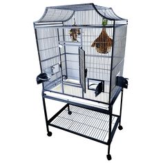 a large bird cage on wheels with two birds in it's top tiers