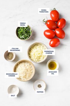 the ingredients for an italian dish laid out on a white counter top, including tomatoes and parmesan cheese