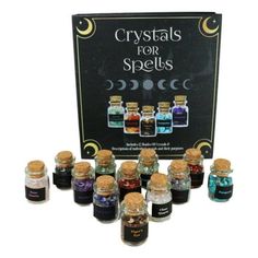 the bottles are filled with different colored liquids and there is a sign that says crystals for spells