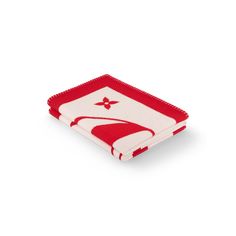 a red and white dish cloth with an image of a bird on the front, against a white background