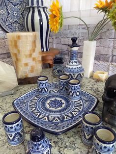 a blue and white table setting with vases