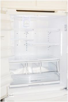 an open refrigerator with the door wide open and no ice maker on it's side