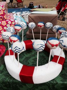 some cake pops are sitting in the shape of a life preserver on a table