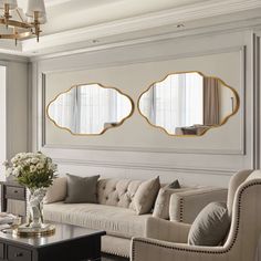 a living room with couches, tables and mirrors on the wall in it's center