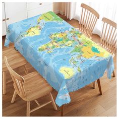 a table covered with a map of the world sitting on top of a hard wood floor