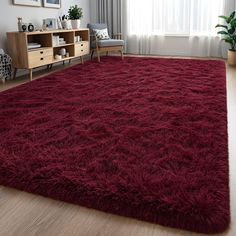 a living room with a large red rug on the floor