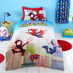 a bed with spiderman sheets and pillows on it