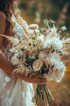 a woman holding a bouquet of flowers in her hands