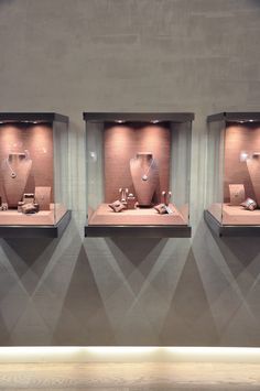 three display cases with jewelry in them on the wall