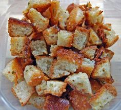 a glass bowl filled with fried food on top of a wooden table