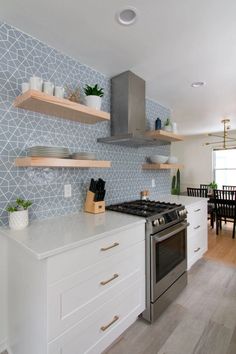 a kitchen with an oven, stove and shelves on the wall next to each other