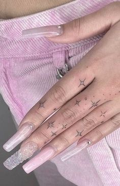 a woman's hand with stars tattooed on it