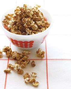 a bowl filled with popcorn sitting on top of a table