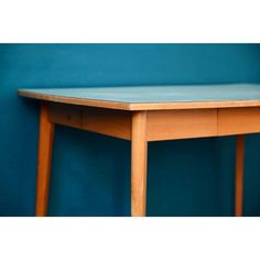 a wooden table against a blue wall