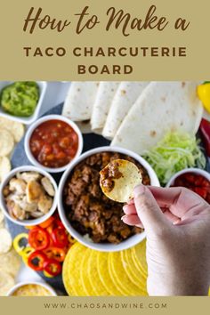 a person holding up a taco in front of many different foods