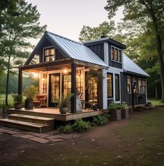 a small house in the woods with stairs leading up to it