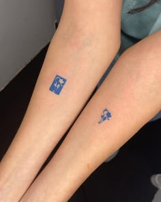 two people with matching tattoos on their legs