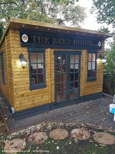 a small wooden building sitting on top of a wooden deck