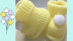 a pair of yellow knitted baby booties sitting on top of a table