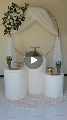 a room with white curtains and gold vases