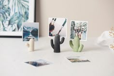 a table topped with photos and cactus figurines