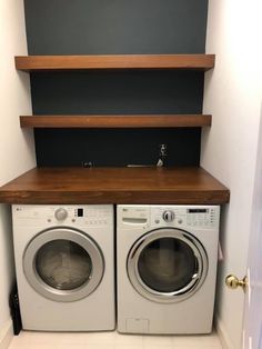 a washer and dryer in a small room with shelves above them that are built into the wall