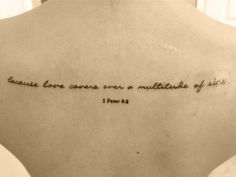 the back of a woman's neck with a quote written on her left shoulder