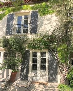 an image of a house that is in the shade with some plants growing on it