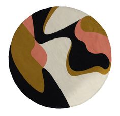 a round rug with an abstract design in black, white, and pink on it