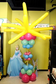 the balloon tree is decorated with princess balloons