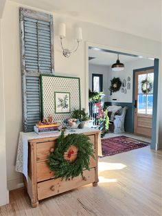 a living room filled with furniture and decor on top of a hard wood floored floor