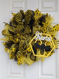 a yellow and black mesh wreath on the front door