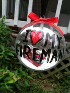 a glass ornament with the words i love my fireman written on it