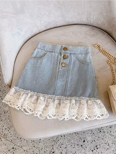 Make casual days extra adorbs with our lace trim denim skirt. Its cute fit and lovely lace details make this a fashion essential for all little style mavens. Pair with a chic bag for a perfectly fab ensemble! Sophisticated details add a touch of elegance to her looks, so her casual 'fits can look prim and polished. Elastic waist design gives her some wiggle room for a premium fit that's ideal for growing little girls. Perfect for fall, preschool, parties, playdates, and year-round fashion statements Denim skirt with button details and lace trim Available in sizes for toddlers and little girls Denim Skirt With Lace, Skirt With Lace Trim, Girls Denim Skirts, Style Mini Skirt, Patchwork Denim Skirt, Denim Skirt Fashion, Skirt Korean, Skirt With Lace, Skirt Casual